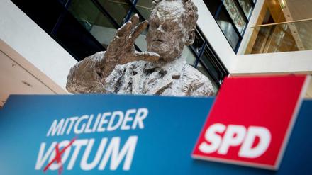 Die Statue von Willy Brandt ist hinter einem Rednerpult mit der Aufschrift "Mitgliedervotum" in der SPD-Parteizentrale zu sehen.
