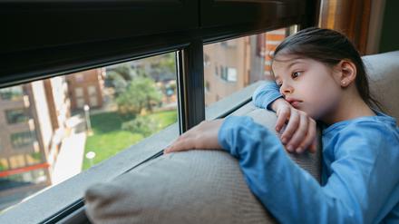 Sad girl looking out the window