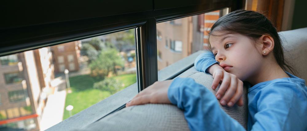 Sad girl looking out the window