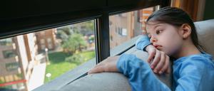 Sad girl looking out the window