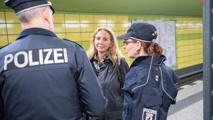 Polizeipräsidentin Barbara Slowik spricht mit Kollegin und Kollege in einem Berliner U-Bahnhof.