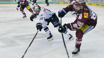 Berlins Mark Olver und Münchens Brooks Macek kämpfen um den Puck.
