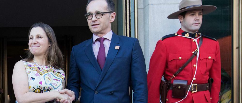 Gut behütet in Toronto: Außenminister Heiko Maas (SPD, Mitte) mit seiner kanadischen Kollegin Chrystia Freeland.