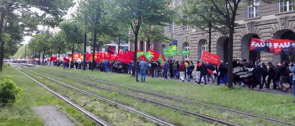Der starke Wind lässt die Fahnen heftig flattern: Der DGB geht bei seiner Demo von 10.000 Teilnehmern aus, die Polizei schätzte zunächst zwischen 3000 und 4000 Demonstranten.
