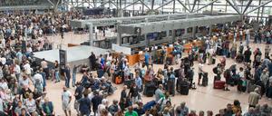 Zahlreiche Flugreisende stehen während eines Stromausfalls im Flughafen Hamburg.
