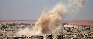 Smoke rises above opposition held areas of Daraa during an airstrike by Syrian regime forces, on June 25, 2018.Russian-backed regime forces have for weeks been preparing an offensive to retake Syria&amp;apos;s south, a strategic zone that borders both Jordan and the Israeli-occupied Golan Heights. / 