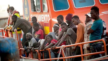 Migranten kommen auf einem Rettungsboot im Hafen von Malaga an.