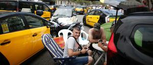 Taxifahrer blockieren mit Tischen und Stühlen die Gran Via in Barcelona, während sie an einem Streik teilnehmen. Aus Ärger über zu viele Lizenzvergaben an Konkurrenz-Unternehmen wie Uber und Cabify sind die Taxifahrer in einen unbefristeten Streik getreten.