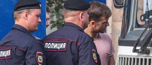 Ein Mitglied von "Pussy Riot" wird von Polizisten abgeführt.