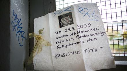 Am S-Bahnhof Wehrhahn erinnert eine Pappe mit Aufschrift an den Anschlag. 