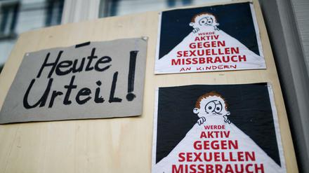 Mitglieder der Initiative "Aktiv gegen Missbrauch" haben ein Plakat vor dem Landgericht angebracht. 