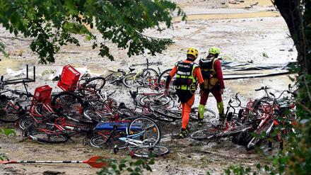 Saint-Julien-de-Peyrolas in Südfrankreich: Rettungskräfte laufen über einen überschwemmten Campingplatz.