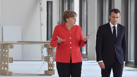 German Chancellor Angela Merkel and French President Emmanuel Macron arrive to give a joint press conference on April 19, 2018 in Berlin before holding talks at the Humboldt Forum in the Berlin Palace still under construction.French President Emmanuel Macron headed to Berlin for talks with Chancellor Angela Merkel, hoping to breathe fresh life into his grand vision for EU reforms in the face of growing German resistance. / 