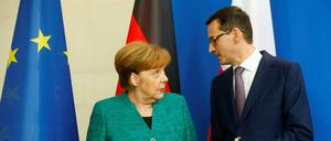 Chancellor Angela Merkel and Polish Prime Minister Mateusz Morawiecki address a news conference in Berlin, Germany, February 16, 2018. REUTERS/Hannibal Hanschke