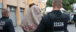 Polizisten führen einen verdächtigen Mann nach einer Razzia gegen kriminelle Mitglieder arabischer Großfamilien Ende August ab.