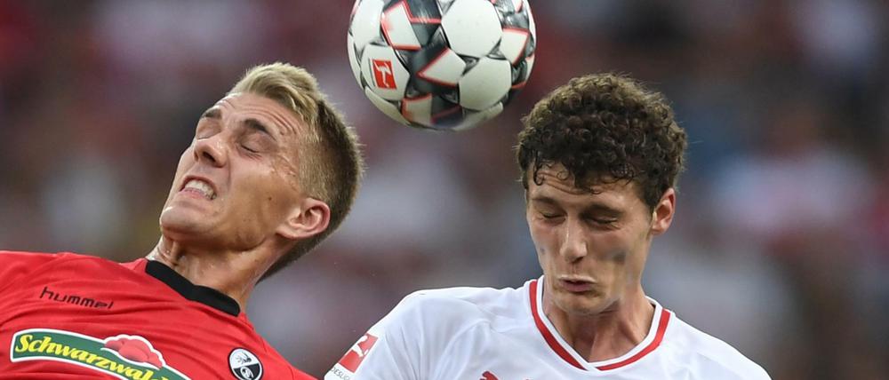 Nils Petersen (l) von Freiburg kämpft mit Benjamin Pavard (r) von Stuttgart um den Ball. 