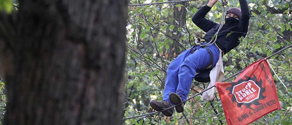 Ein Umweltaktivist klettert zwischen zwei Bäumen. Die Räumung der Baumhäuser von Umweltaktivisten im Hambacher Forst geht weiter.