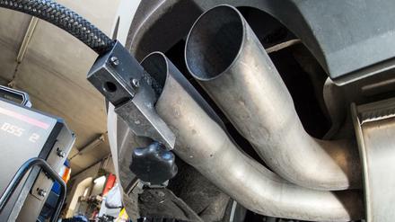 Ein Messschlauch eines Geräts zur Abgasuntersuchung für Dieselmotoren steckt im Auspuffrohr eines VW Golf.