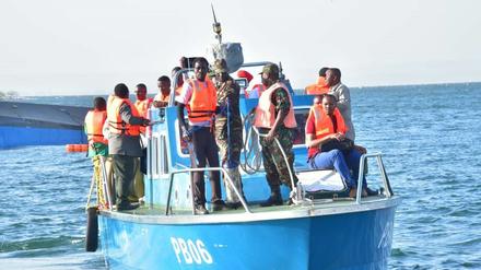 Rettungskräfte stehen auf einem Boot in der Nähe des Unglücksortes auf dem Victoriasee, dem größten See Afrikas.