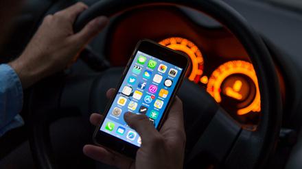 In diesem Fall gestellt - aber auch in der Realität eine häufige Szene: In einer Hand das Handy, in der anderen das Lenkrad.
