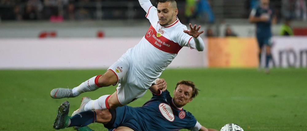 Gelegt. Düsseldorfs Adam Bodzek (unten) foult Stuttgarts Anastasios Donis. Die Schwaben haben es derzeit schwer.