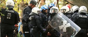 Im Hambacher Forst tragen Polizisten einen Demonstranten weg.