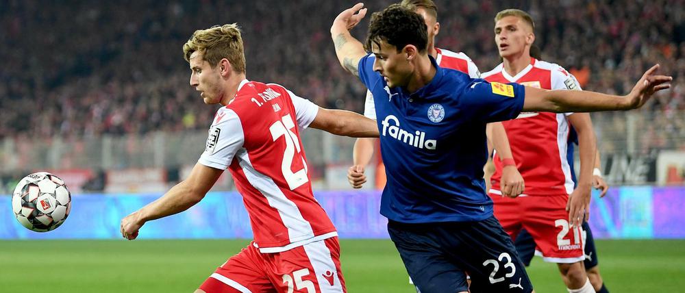 Erst am Ende turbulent. Unions Christopher Lenz (l), Kieler Janni Serra und Unions Grischa Prömel kämpfen um den Ball. 