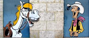 Erfolgsteam. Seit mehr als 70 Jahren reiten Lucky Luke und Jolly Jumper - hier ein Wandbild in Angouleme - durch den Wilden Westen.