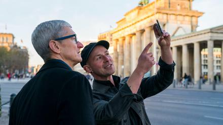 Apple-Chef Tim Cook (links) lässt sich am Brandenburger Tor von Entwickler Peter Kolski das Projekt «MauAR» erklären. Kolski lässt die Berliner Mauer an ihrem historisch korrekten Ort wieder sichtbar werden. 