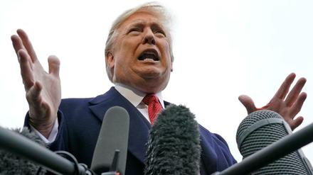 U.S. President Donald Trump speaks to reporters as he departs the White House en route to Paris from Washington, U.S., November 9, 2018. REUTERS/Kevin Lamarque