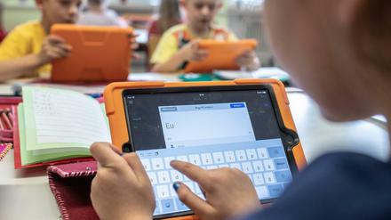 Grundschüler arbeiten mit Tablets.