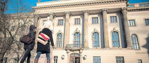 Studierende gehen auf das Hauptgebäude der Humboldt-Universität zu Berlin zu.
