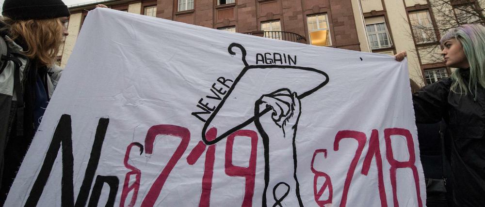Mit einem Plakat sprechen sich Demonstrantinnen für die Abschaffung des Paragrafen 219 und 218 aus.