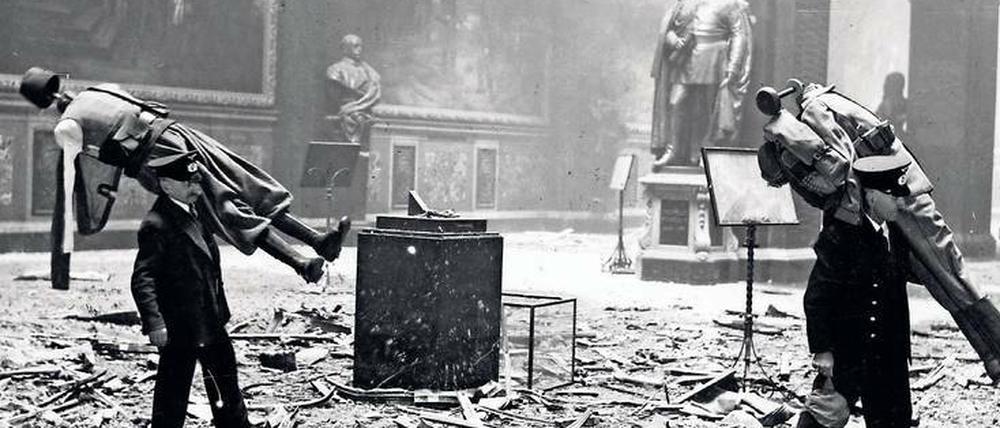 Bei Alliiertenangriffen wurde auch das Zeughaus teilweise zerstört. Angestellte tragen Puppen mit Uniformen aus der Ruhmeshalle.