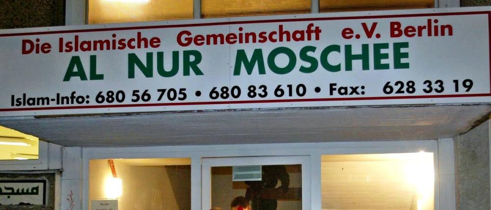 Ein Polizeibeamter geht während einer Durchsuchung in die Al Nur Moschee in Berlin.