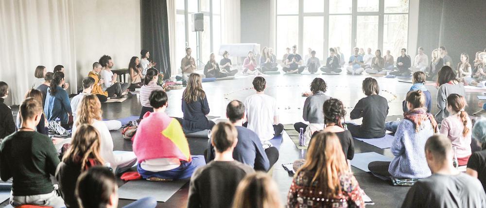 Die Teilnehmer der Kakao-Zeremonie machen es sich für eine einstündige, geführte Meditation bequem.