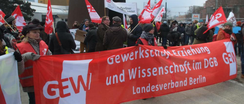 Demonstranten mit einem Banner der GEW demonstrieren vor der Philharmonie.