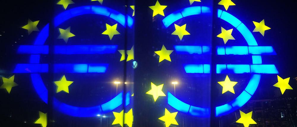 Die Euro-Skulptur spiegelt sich in Frankfurt am Main vor der Europäischen Zentralbank (EZB) in einer Scheibe.