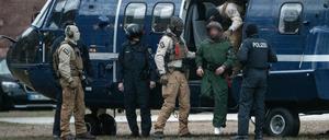 Beamte der Bundespolizei führen einen mutmaßliche Terrorverdächtigen aus einem Helikopter. 