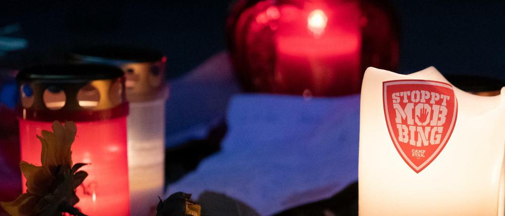 Auf den Stufen zum Eingang der Hausotter-Grundschule in Reinickendorf steht eine Kerze mit der Aufschrift "Stoppt Mobbing".