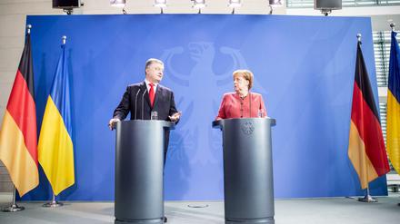 Kanzlerin Angela Merkel steht neben dem ukrainischen Präsidenten Petro Poroschenko.