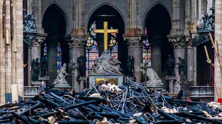 Trümmerteile und verkohlte Holzbalken liegen im Inneren der Kathedrale Notre-Dame.