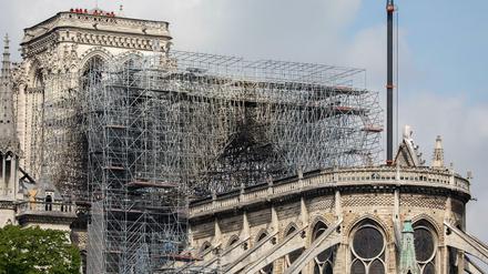 Feuerwehrmänner stehen auf dem Dach eines Turmes der Pariser Kathedrale Notre-Dame. 