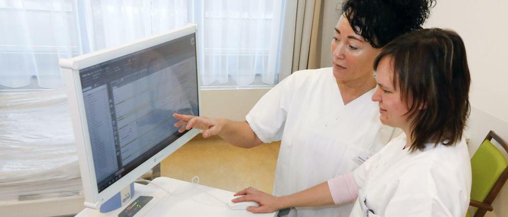 Gläserner Patient? Zwei Krankenschwestern informieren sich digital.