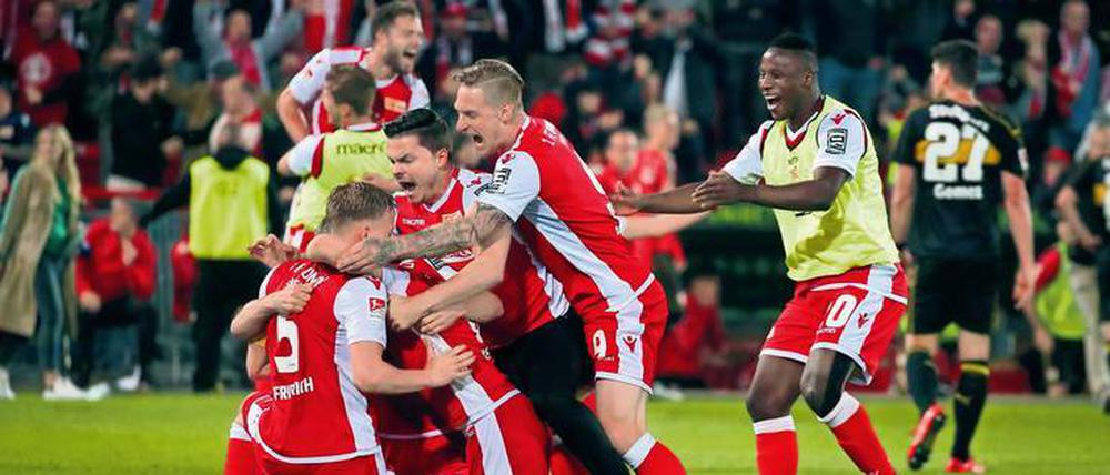 Feierbiester sind sie auch. Unions Spieler bildeten nach dem Abpfiff eine Jubeltraube – und feierten anschließend bis tief in die Nacht ihren Aufstieg in die Bundesliga. Fotos: Sportfoto Rudel, Jan Hübner/Imago (2)