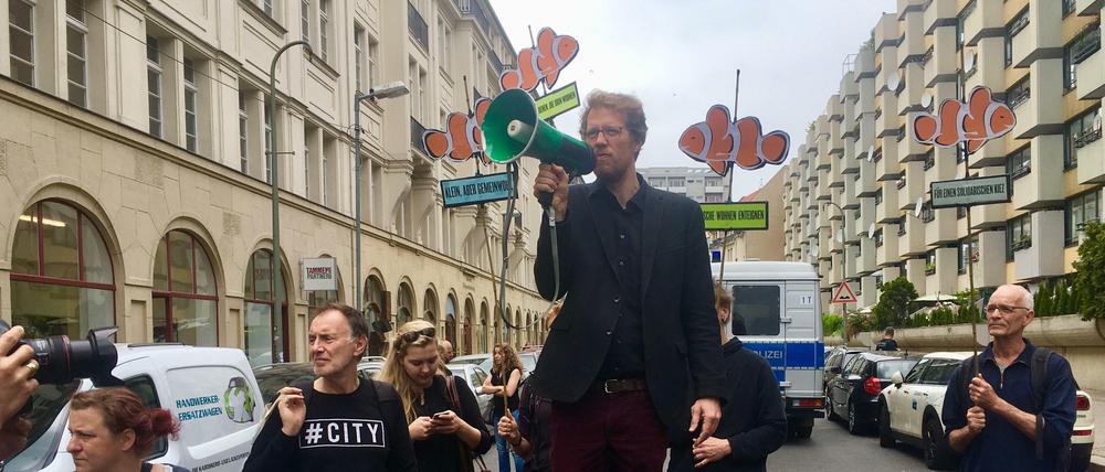 Kreuzbergs Baustadtrat Florian Schmidt (Grüne) bei der Kundgebung gegen den Verkauf von 500 Sozialwohnungen (rechts) in der südlichen Friedrichstadt.