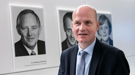 Ralph Brinkhaus vor Porträts seiner Vorgänger.