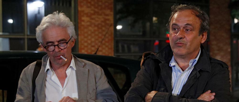 Entlassen, aber entlastet wohl noch nicht. Michel Platini (rechts) und sein Anwalt William Bourdon (mit der Zigarette danach) verlassen die Polizeistation.