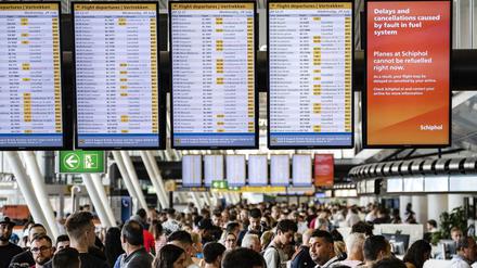 Lauter Verspätungen und Annulierungen – und unter den Tafeln ratlose Passagiere am Amsterdamer Flughafen.