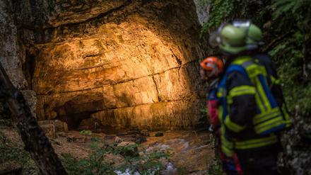 Einsatzkräfte stehen am Eingang der Falkensteiner Höhle bei Grabenstetten. 